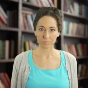 Serious woman with dark hair in an updo